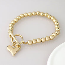 Load image into Gallery viewer, Golden bead and heart charm t-bar bracelet
