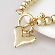 Load image into Gallery viewer, Golden bead and heart charm t-bar bracelet
