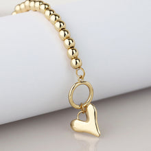 Load image into Gallery viewer, Golden bead and heart charm t-bar bracelet

