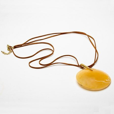 Large circular resin pendant on long twin suede