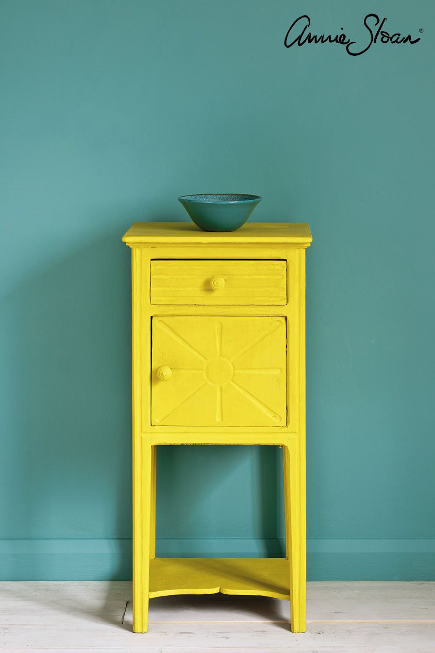 Side table painted in Annie Sloan English Yellow Chalk Paint against a wall painted Provence